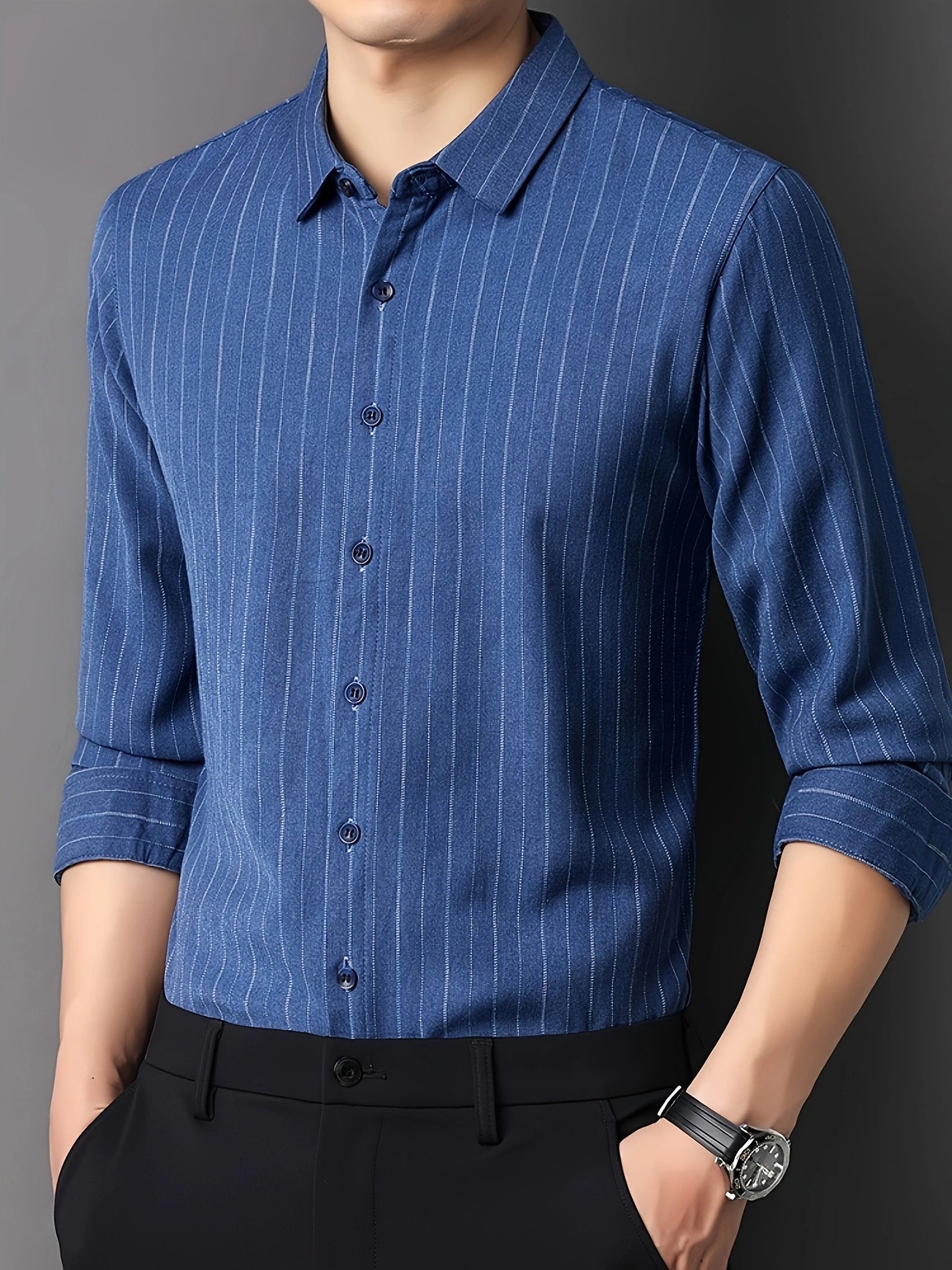 GKSEN royal blue pinstripe men’s shirt shown in a three-quarter front model pose with collar, buttons, and rolled sleeves visible.