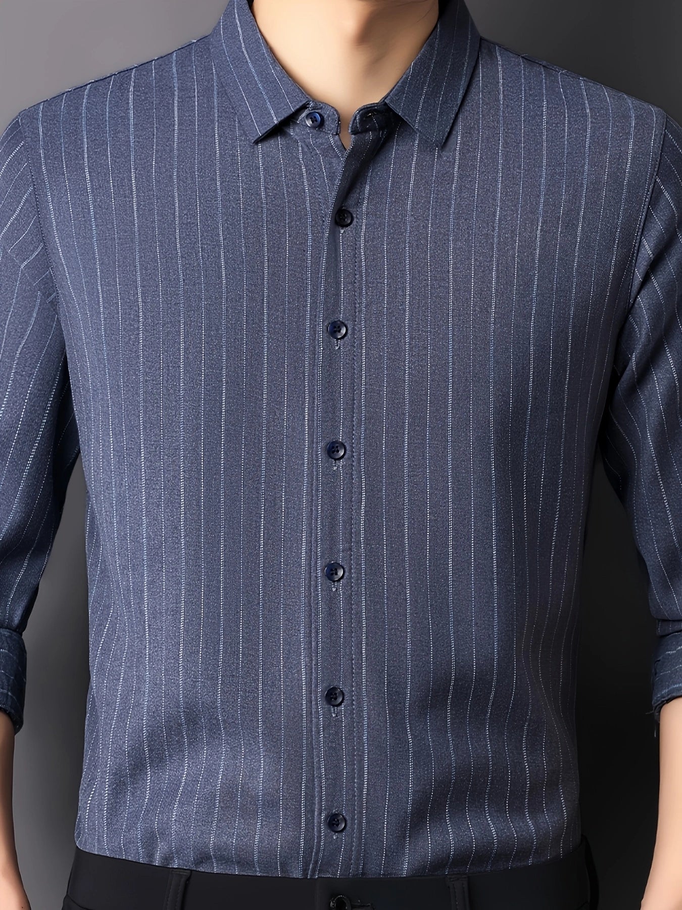 Close-up view of GKSEN blue pinstripe men’s shirt showing collar, dark buttons, vertical stripes and refined fabric texture.