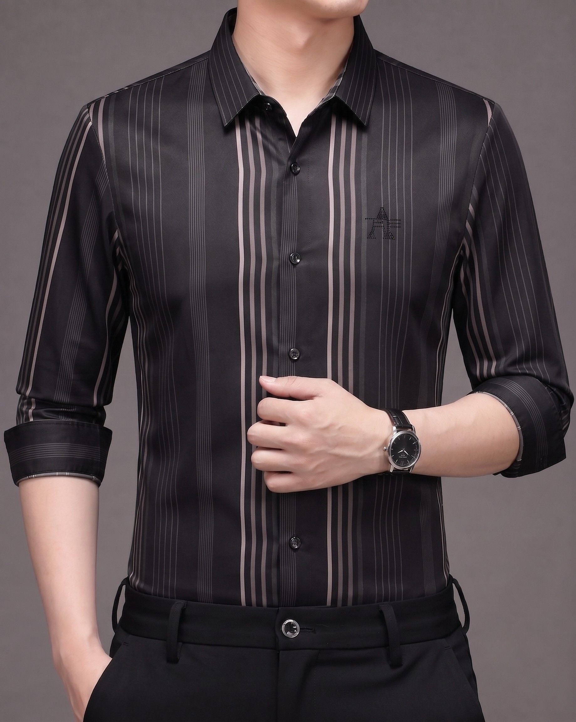 Model wearing GKSEN men's black and smoky taupe vertical stripe Imported Stretch shirt with black trousers