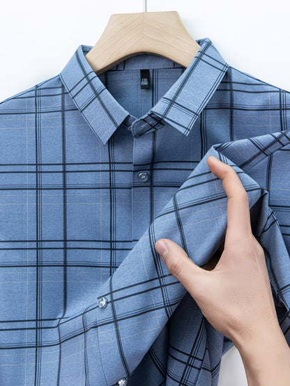 Close hanger view of the GKSEN denim blue windowpane check men’s shirt showing the collar, buttons, folded sleeve detail, and grid check pattern.