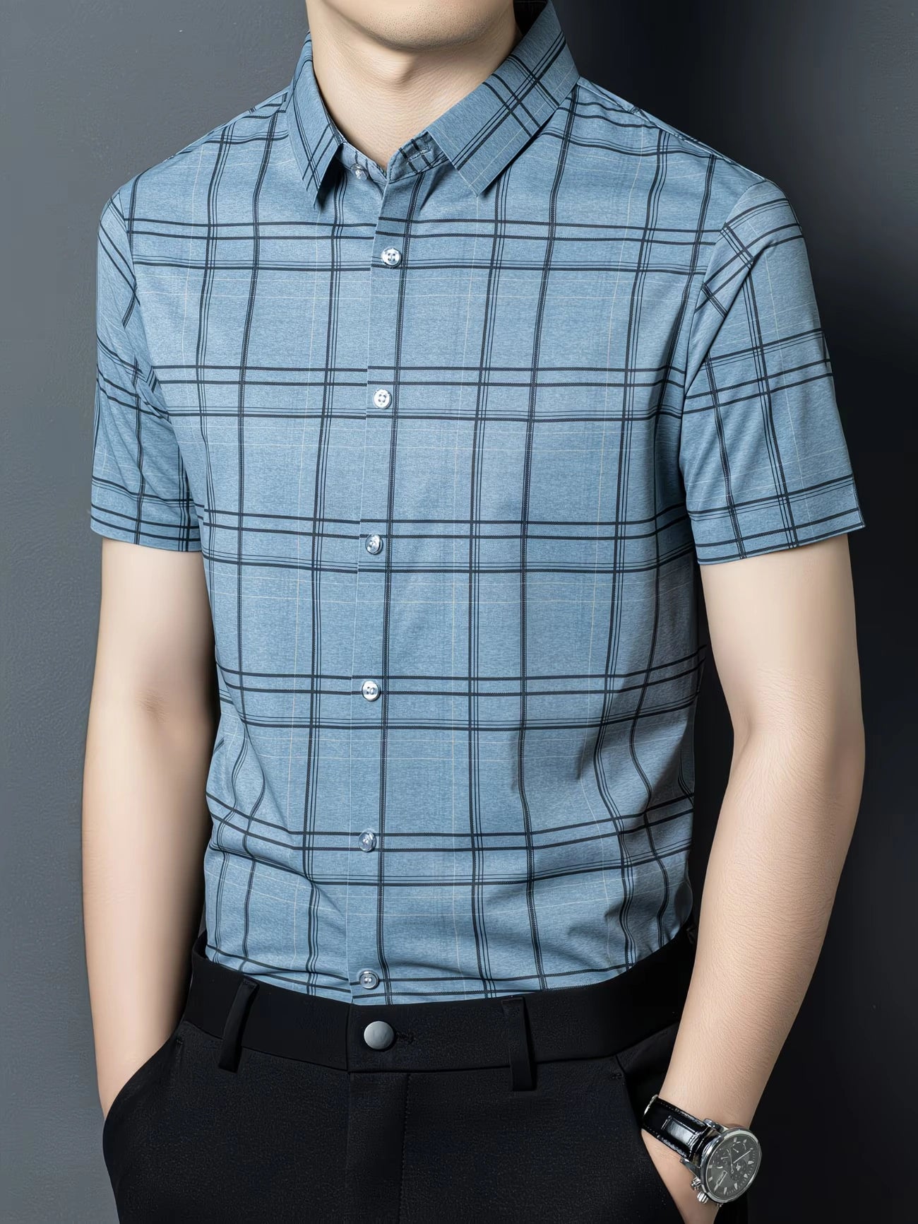 GKSEN dusty blue windowpane check men’s shirt shown in a three-quarter front model pose with short sleeves and collar detail.