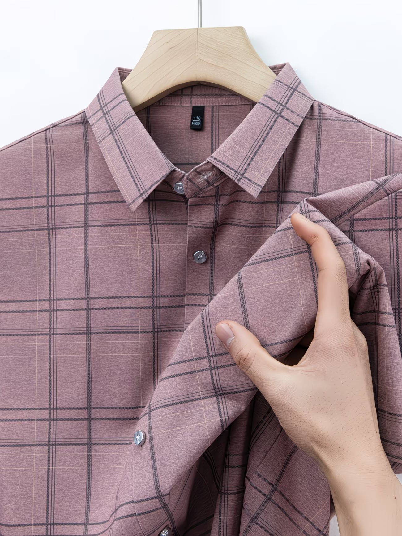 Close hanger view of the GKSEN dusty mauve check men’s shirt showing the collar, buttons, sleeve fold, and windowpane check pattern.