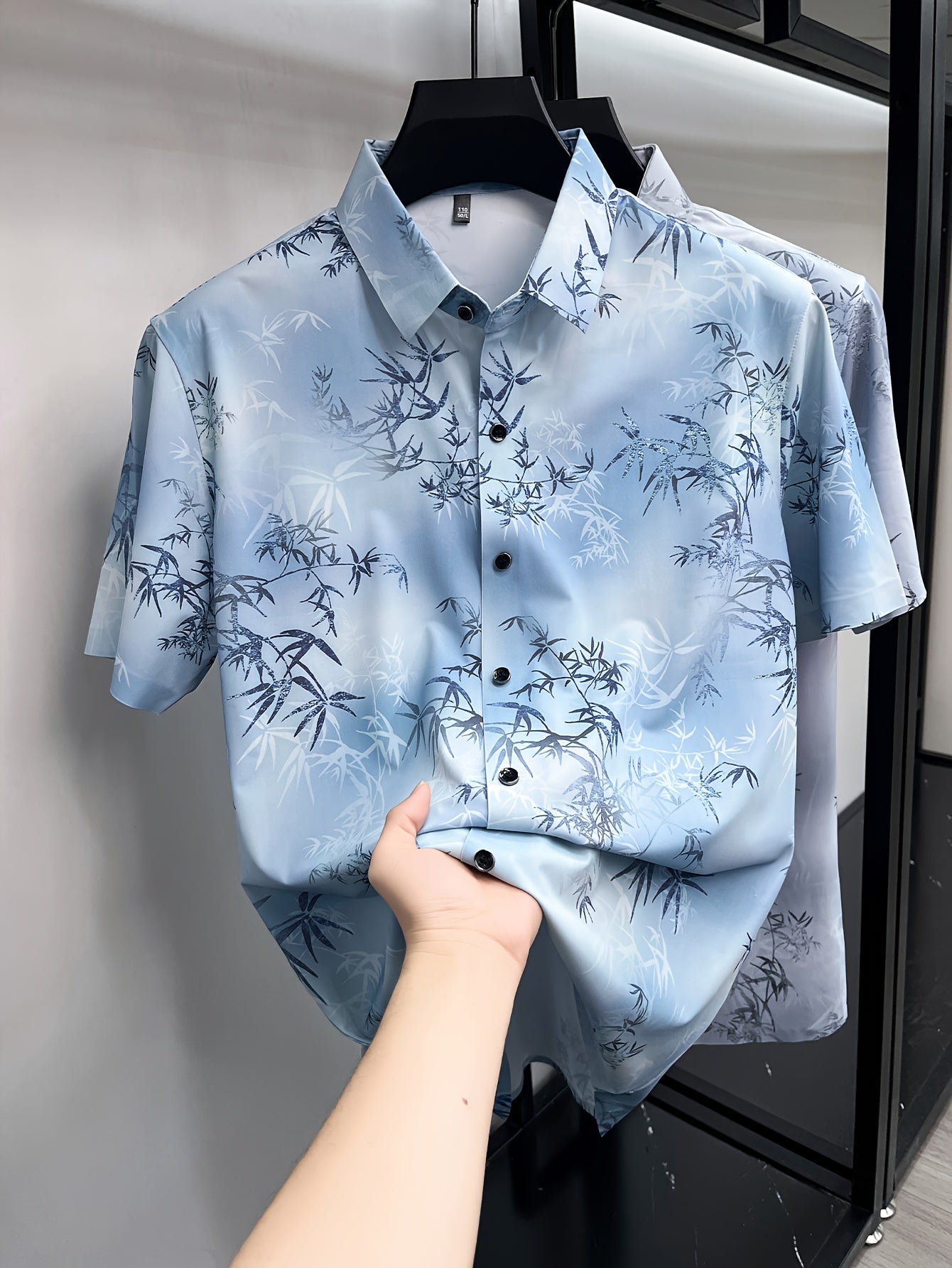 GKSEN ice blue bamboo leaf print men’s shirt shown in a front hanger view with collar, buttons, and all-over print visible.
