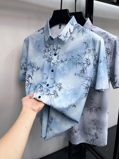GKSEN light blue botanical print men’s shirt shown on a hanger with short sleeves and bamboo leaf pattern across the front.