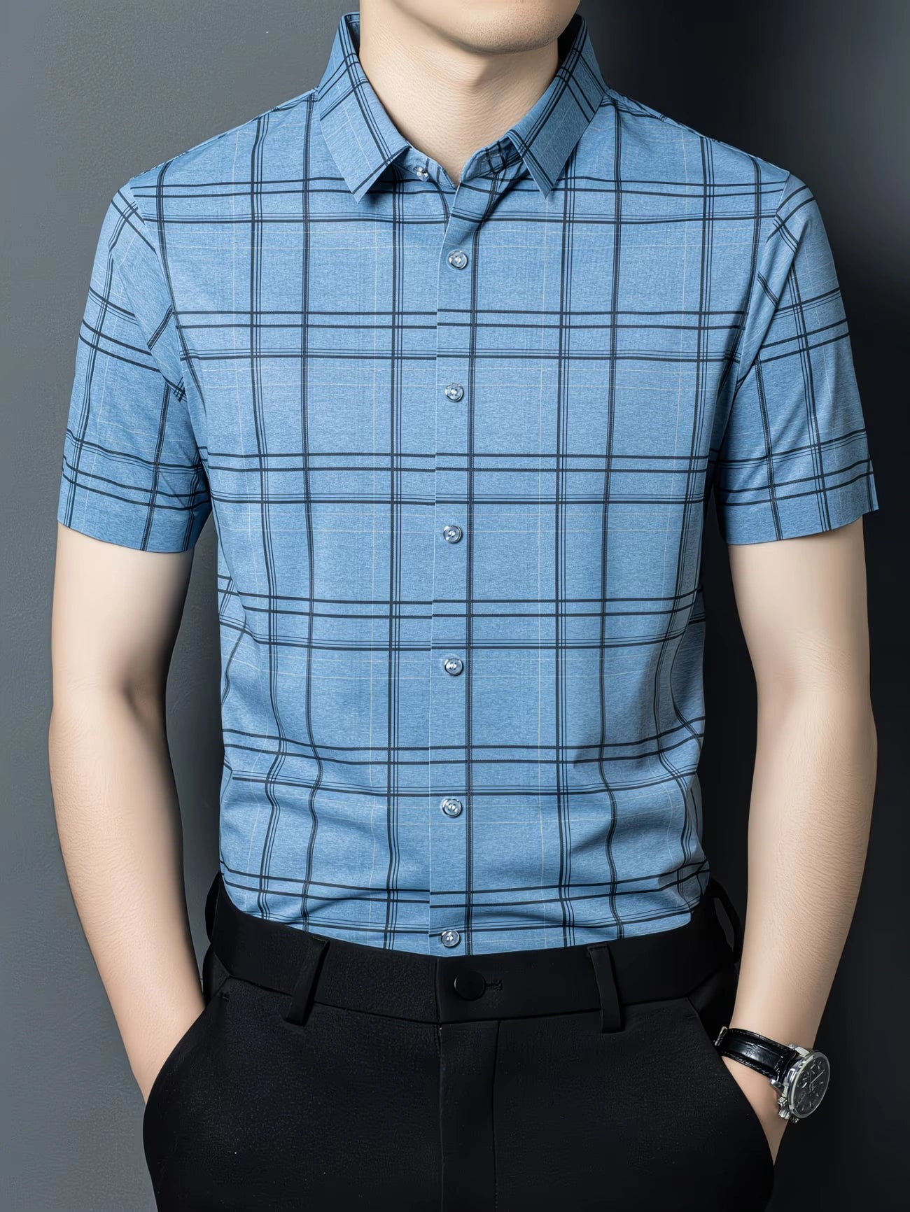 GKSEN light blue windowpane check men’s shirt shown in a front model pose with short sleeves, collar, and light button detail.
