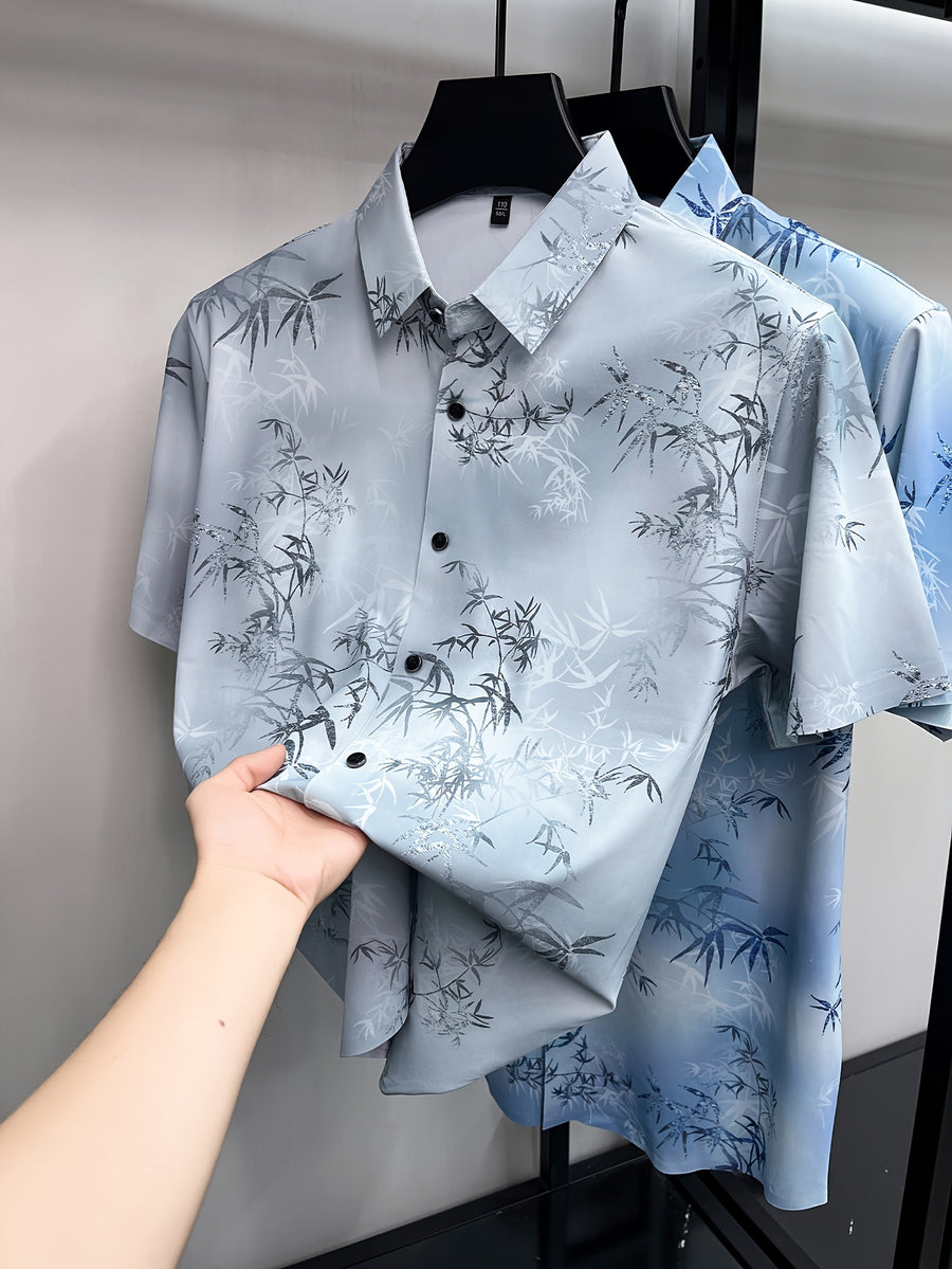 GKSEN men’s shirt in mist grey bamboo print shown on a hanger with short sleeves, black buttons, and front folded detail visible.