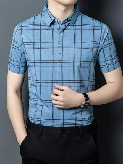 GKSEN sky blue windowpane check men’s shirt shown from the front with the model adjusting the shirt and short sleeve styling visible.
