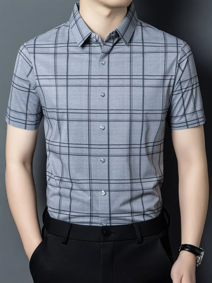 GKSEN slate grey check men’s shirt shown in a clean front view with short sleeves, light buttons, and black trousers.