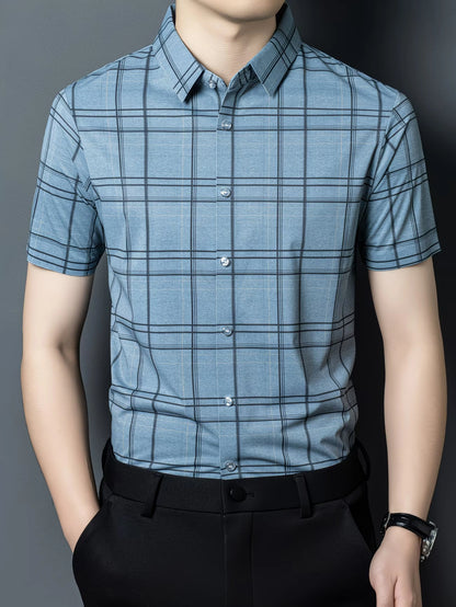 GKSEN soft blue grid check men’s shirt shown in a clean front view with short sleeves, light buttons, and black trousers.