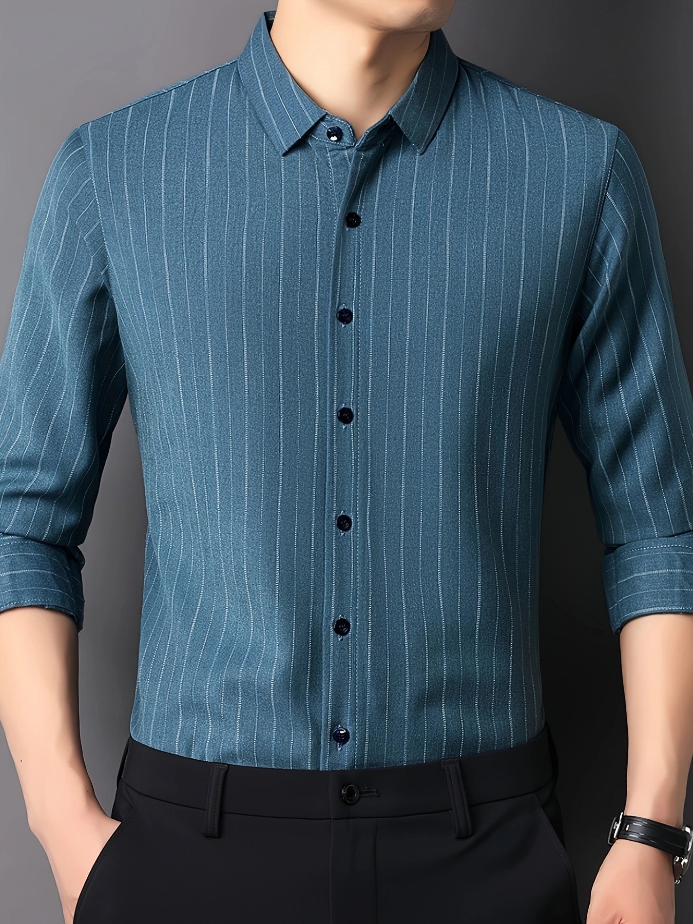 GKSEN teal blue pinstripe men’s shirt shown in a three-quarter front model pose with collar, buttons, and rolled sleeves visible.