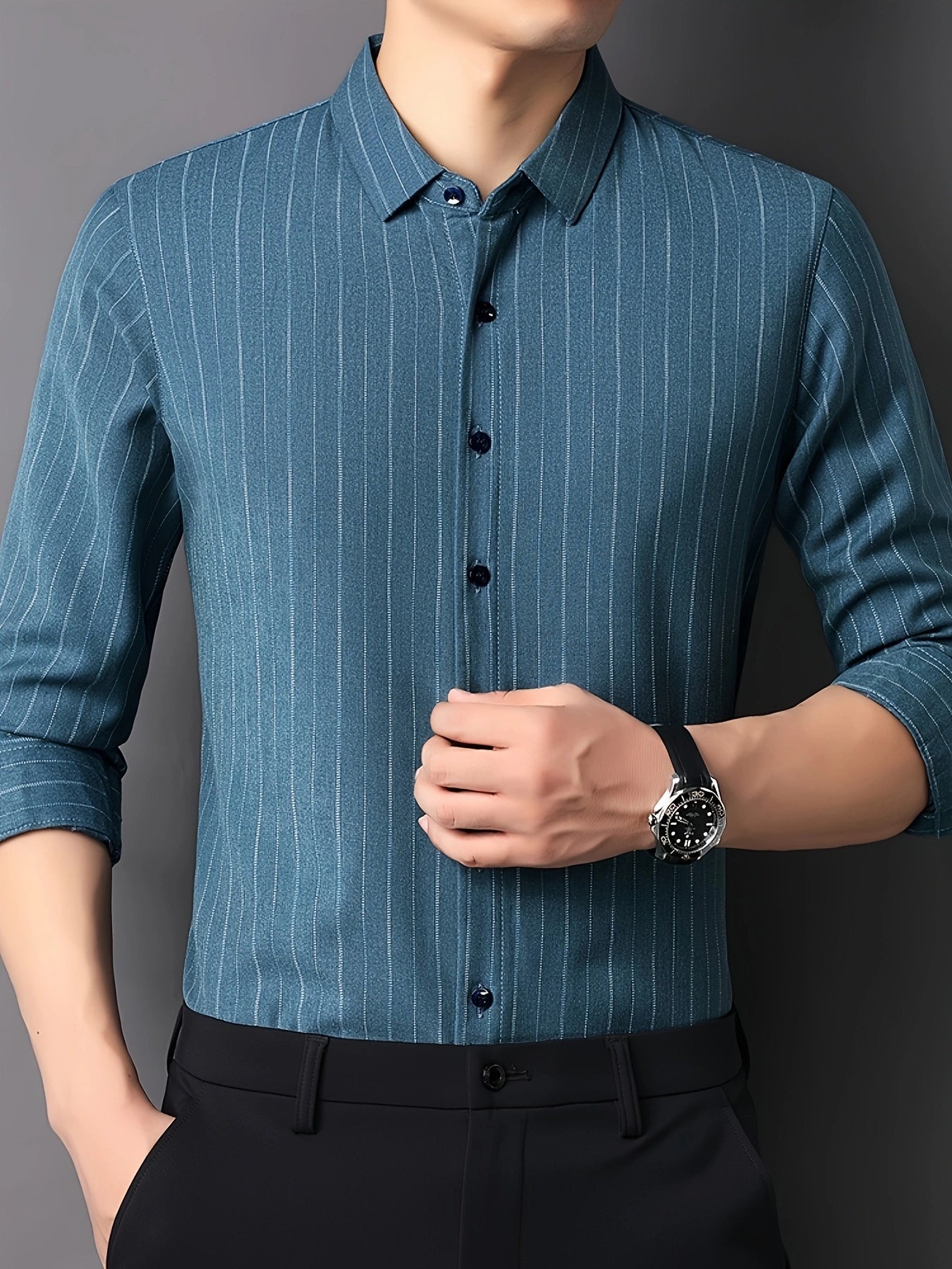 GKSEN men’s shirt in teal blue vertical stripes shown from the front with a clean smart casual model pose.