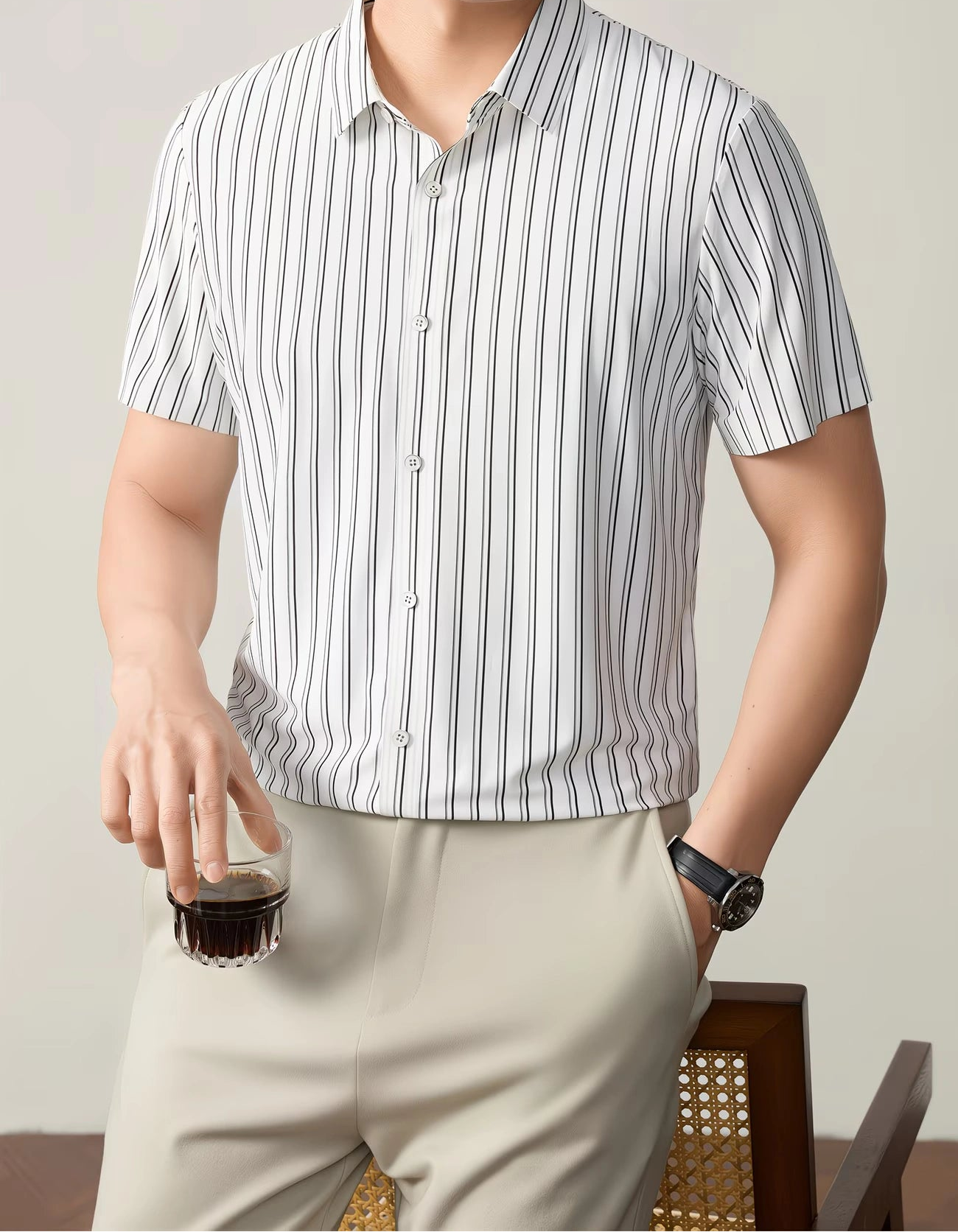 GKSEN men’s shirt in white with black vertical stripes shown in a front model pose with short sleeves and glass-in-hand styling.