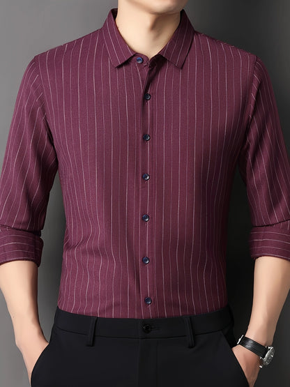 GKSEN wine burgundy pinstripe men’s shirt shown from the front with the model adjusting the shirt and sleeve styling visible.