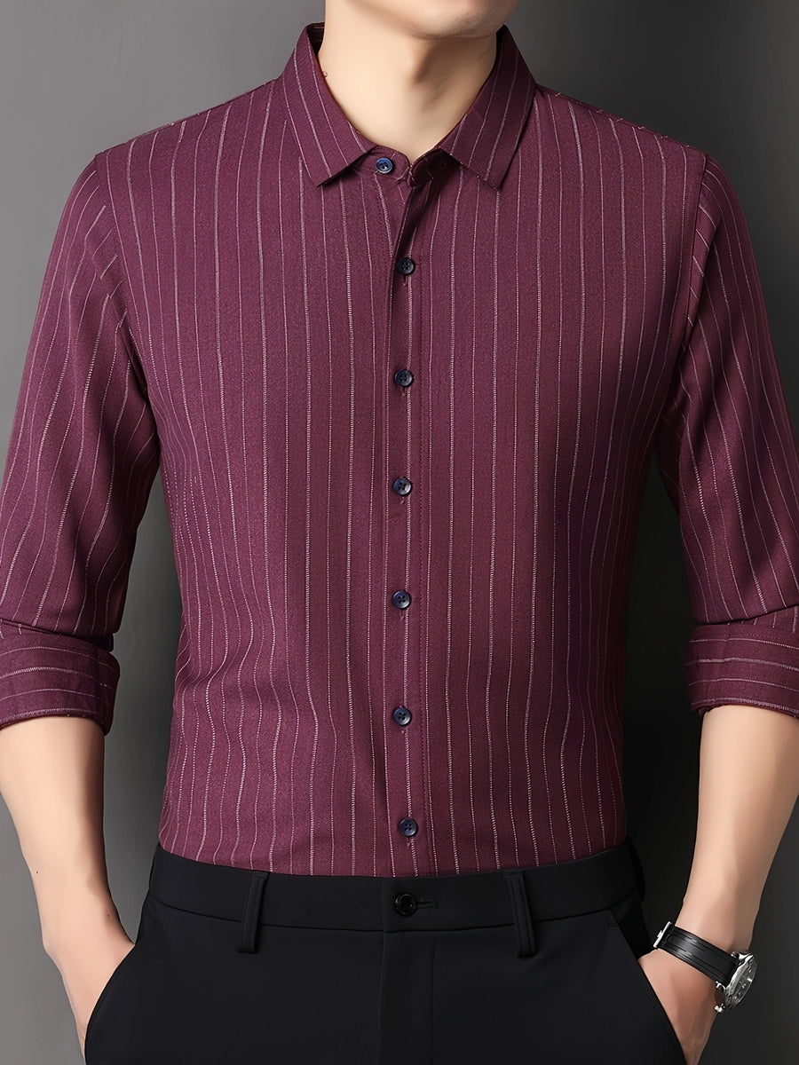 GKSEN wine burgundy pinstripe men’s shirt shown from the front with the model adjusting the shirt and sleeve styling visible.