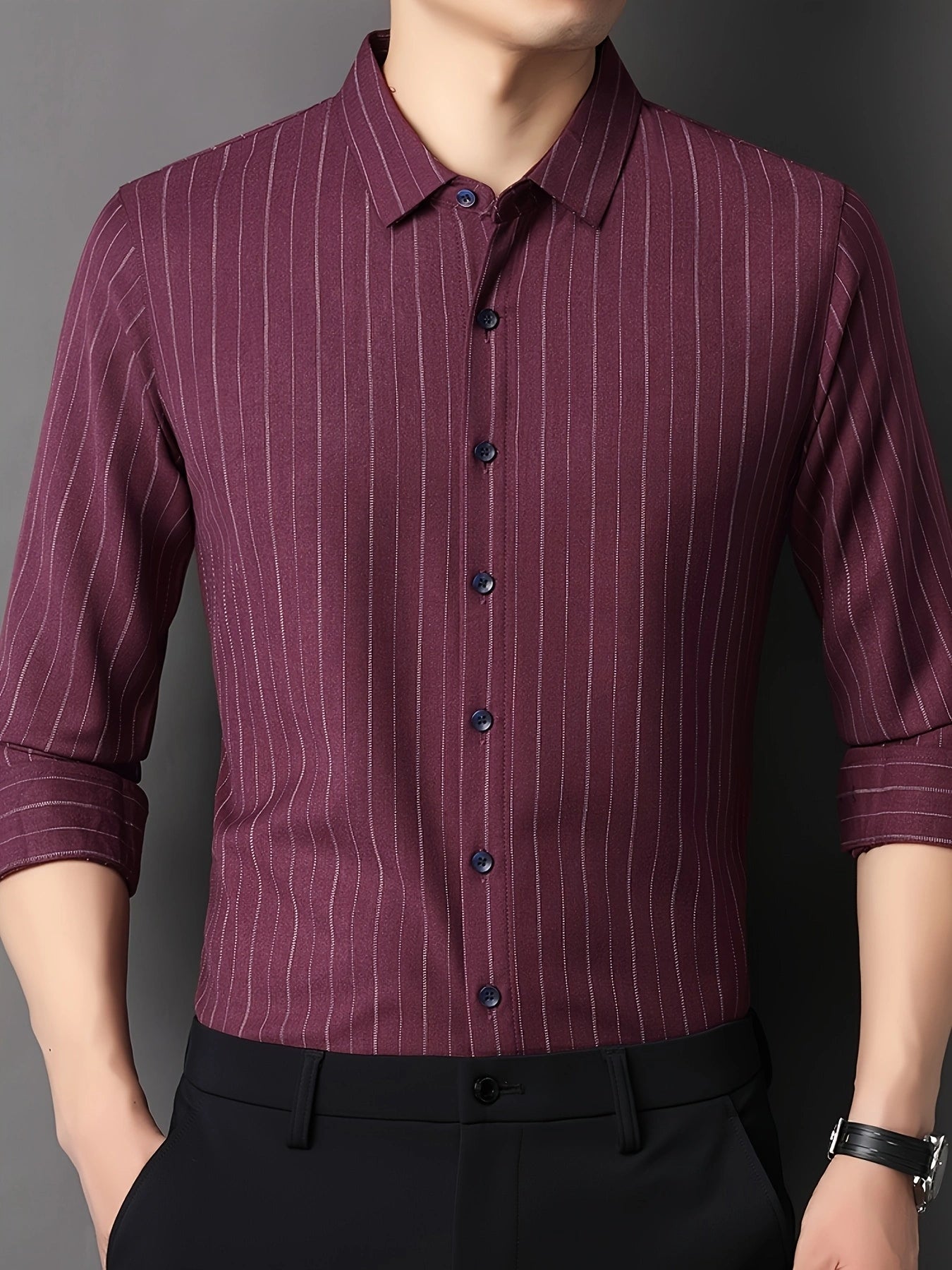 GKSEN men’s shirt in wine burgundy vertical stripes shown in a front view model pose with rolled sleeves and hands near the pockets.
