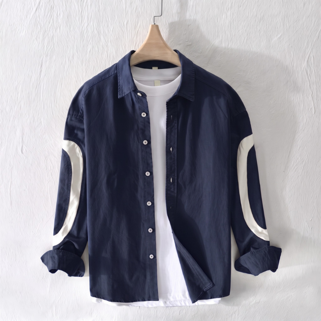 GKSEN men's navy cotton shirt with off-white curved sleeve panels shown hanging over a white T-shirt
