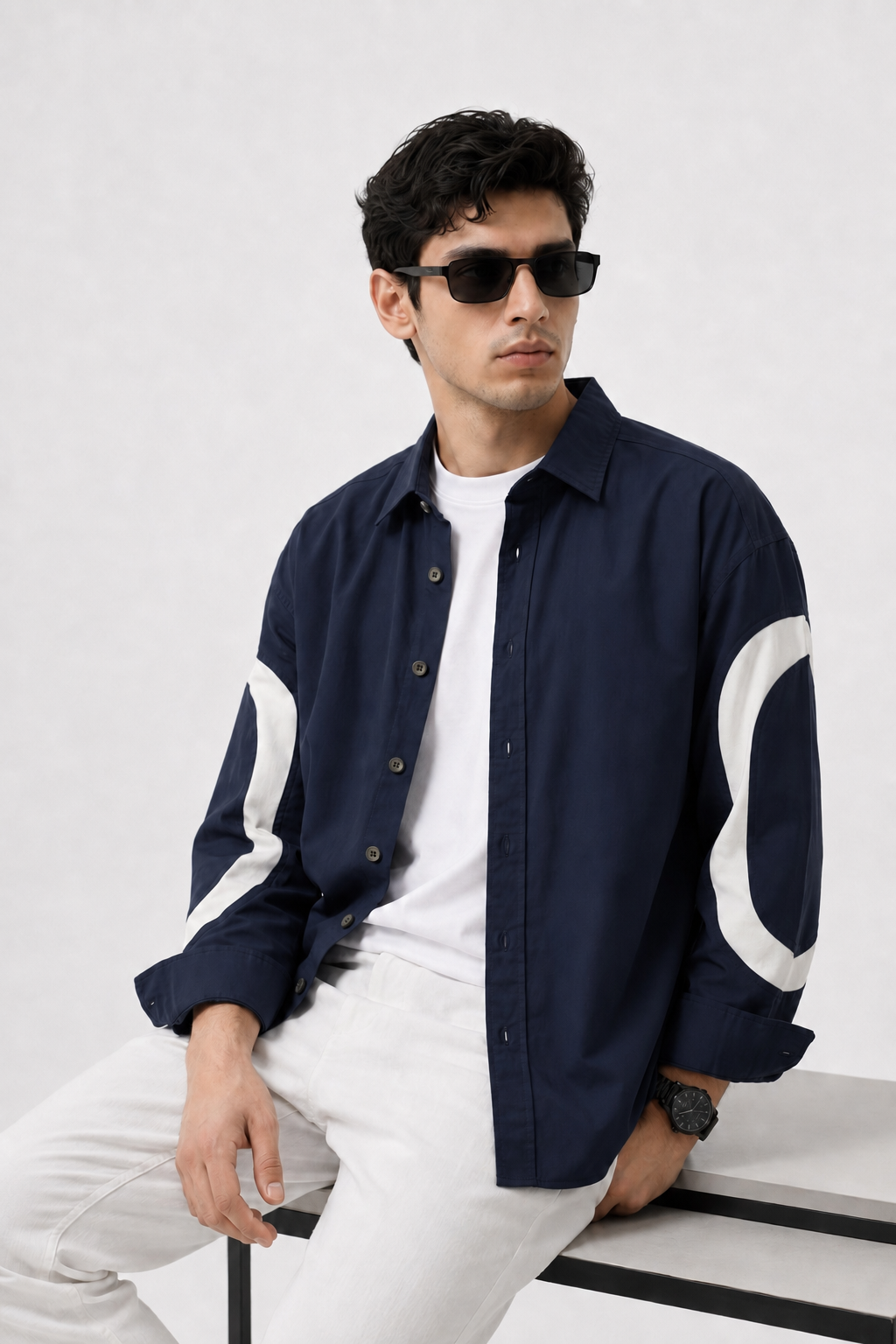 GKSEN men's deep navy cotton shirt featuring bold off-white curved sleeve detailing in a casual layered outfit