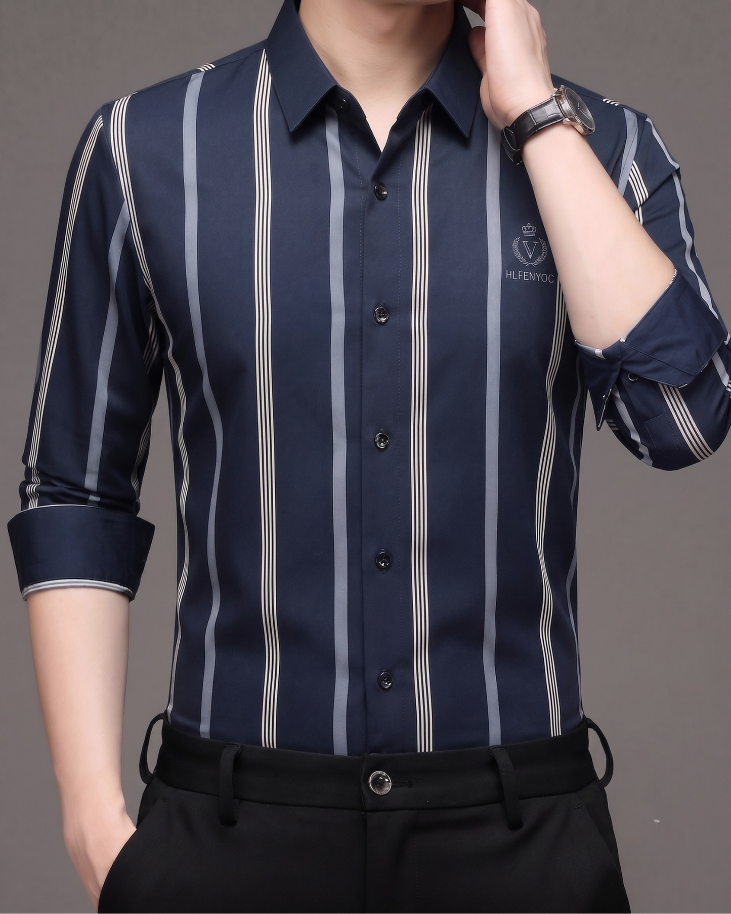 Model wearing GKSEN navy blue striped men's Imported Stretch shirt with silver grey vertical stripes and rolled sleeves