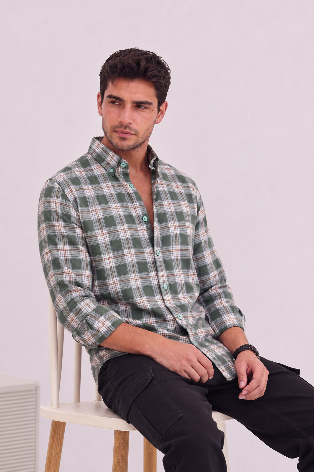 Men’s olive green checked shirt by GKSEN shown in seated smart casual styling