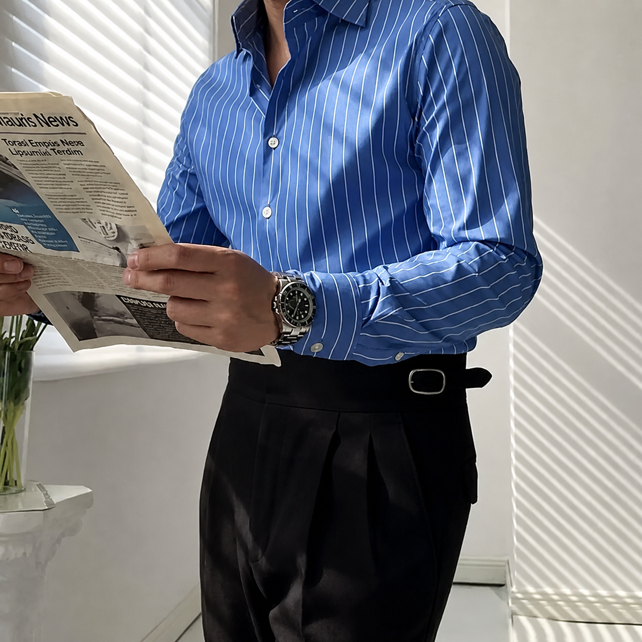 Side pose of GKSEN royal blue vertical stripe office wear shirt paired with black formal trousers.