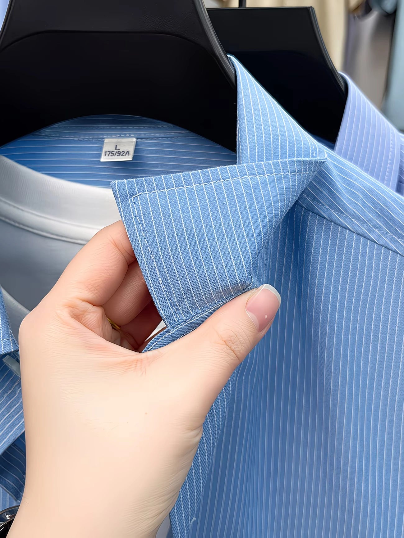 Close-up of collar stitching and fine vertical stripe pattern on GKSEN men’s sky blue shirt.