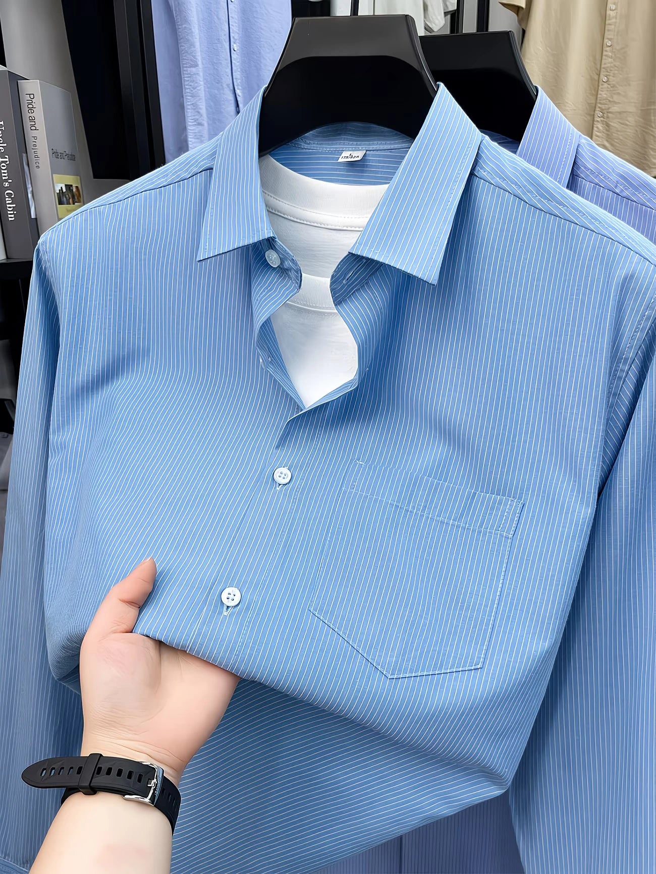 Folded GKSEN sky blue fine stripe full sleeve shirt showing front buttons and chest pocket detail.
