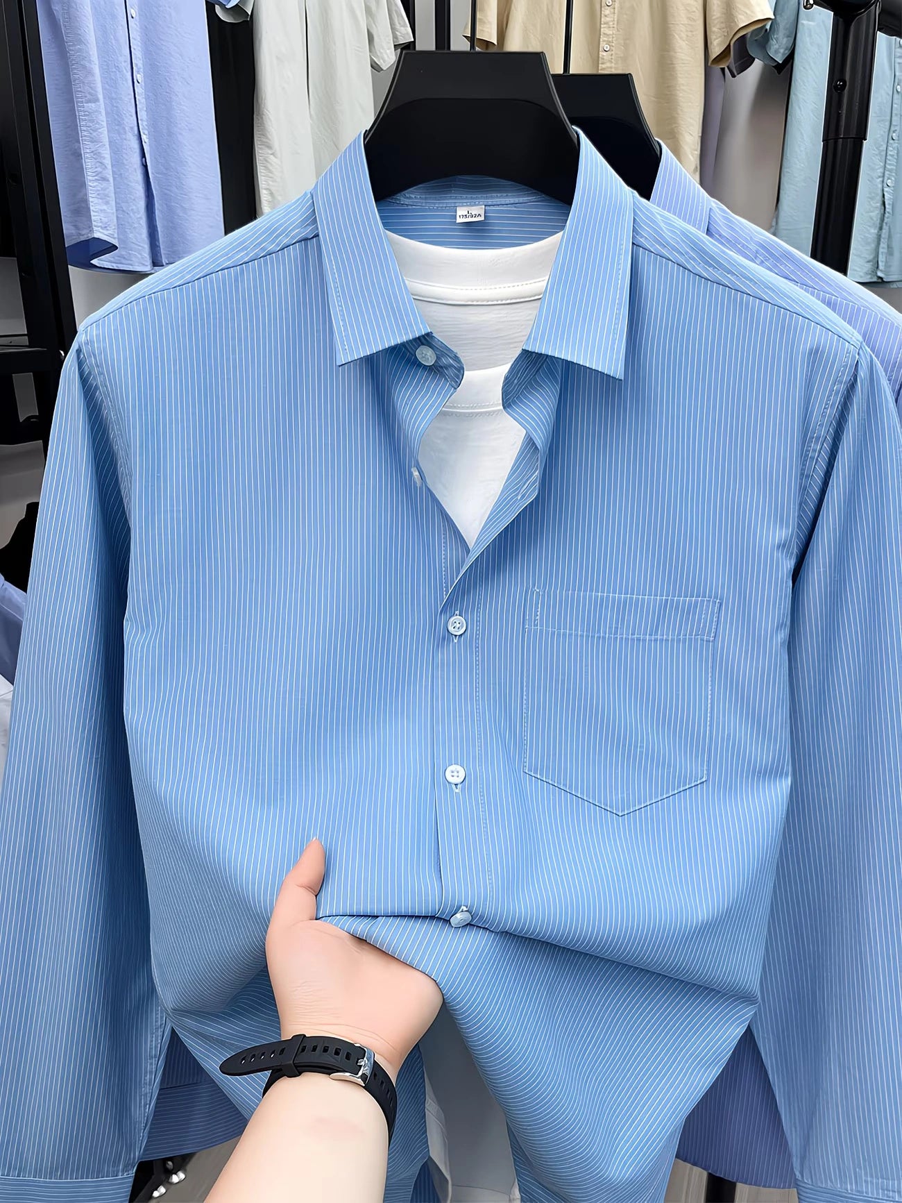 Front view of GKSEN men’s sky blue fine stripe full sleeve shirt with chest pocket on hanger.