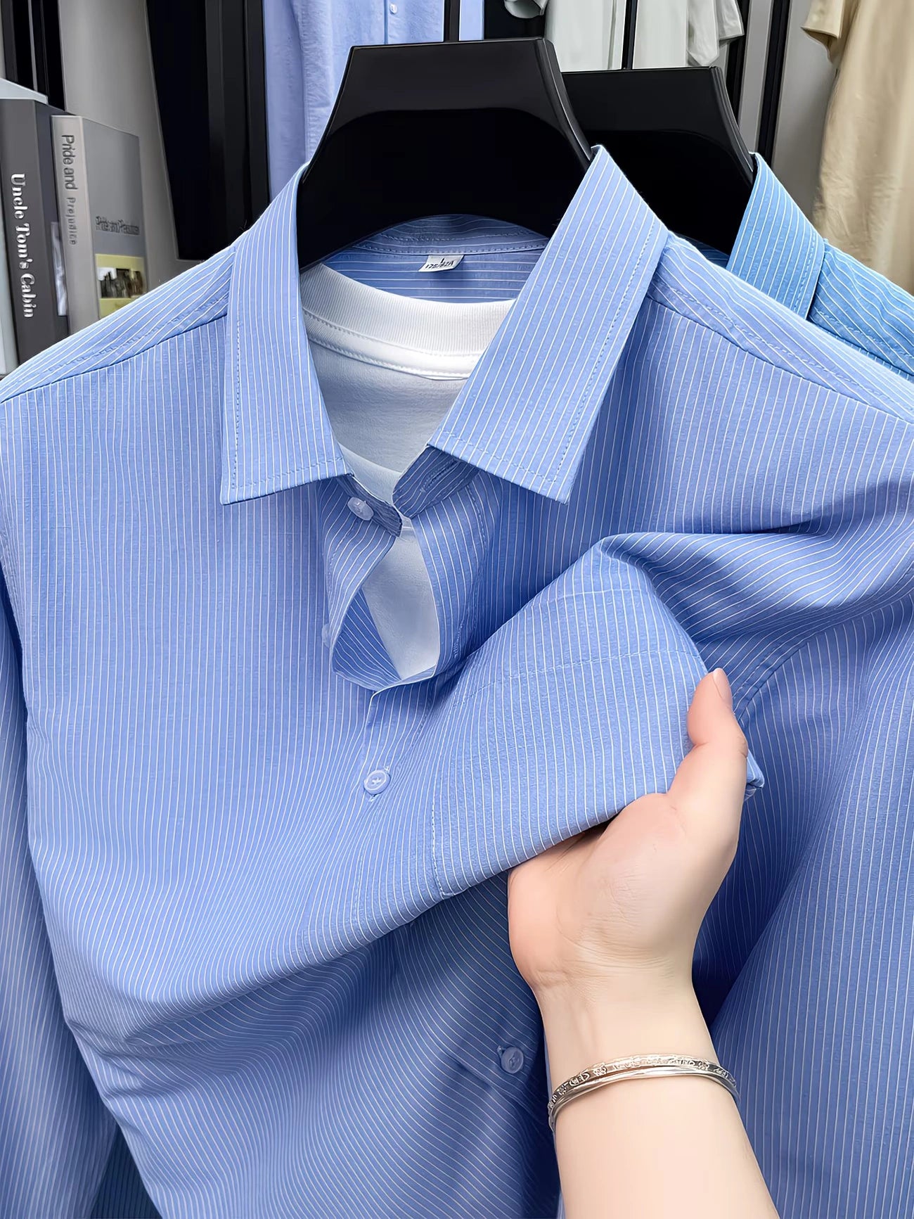 GKSEN sky blue men’s shirt with fine vertical stripes, sharp collar, and button front displayed on hanger.