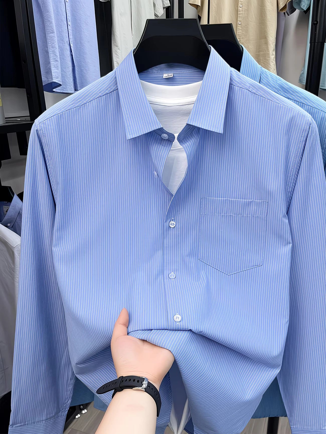 GKSEN sky blue fine stripe men’s shirt displayed on hanger with front pocket and clean formal styling.