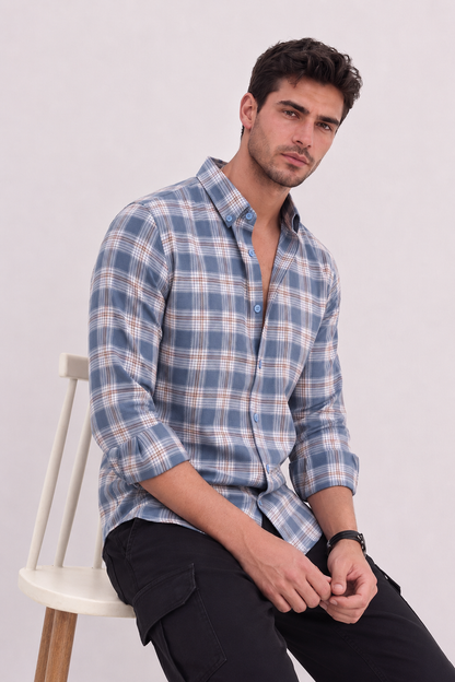 Male model wearing GKSEN slate blue check shirt with white and brown line pattern